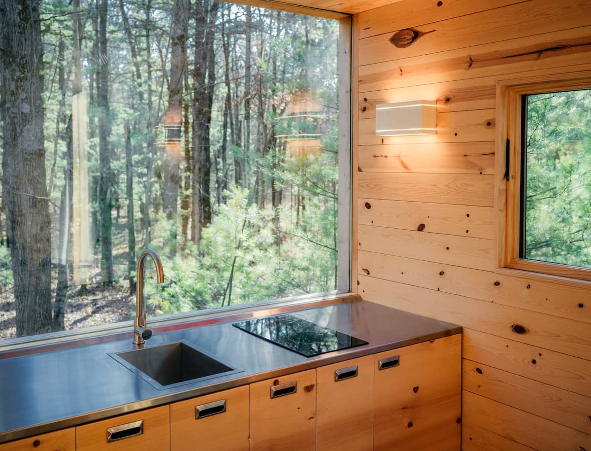 Kitchen with sink, induction stovetop, and mini-fridge