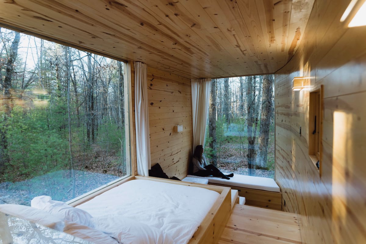 The view after walking in the front door featuring the bed, sunken lounge area, and curved wall.