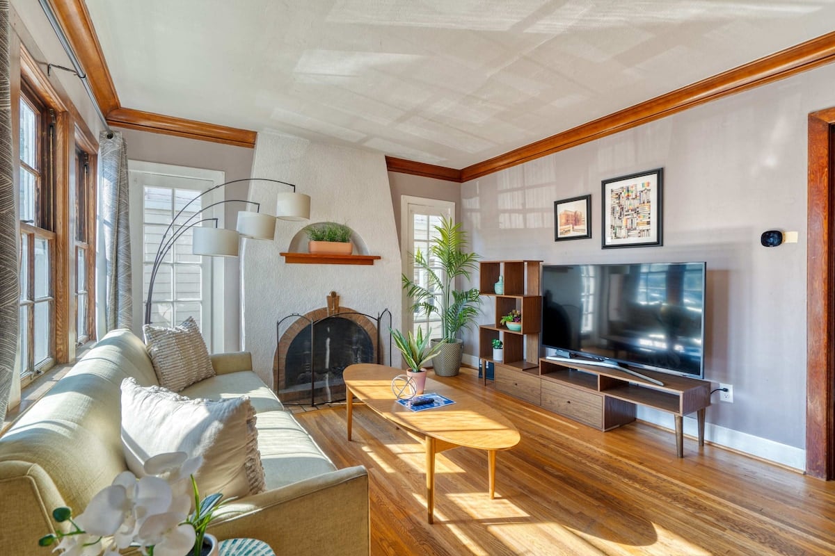 CAPTION: Nestled in the heart of Portland, "Property" exudes timeless elegance with its classic architectural style. The living area boasts a soothing neutral color palette accentuated by natural light filtering through expansive windows. Rich wooden floors and a charming fireplace create a cozy atmosphere, while contemporary decor adds a touch of modernity. Ideal for discerning travelers seeking a blend of comfort and style, this serene retreat promises a luxurious experience with Journey.com.