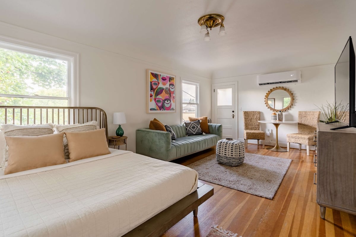 **CAPTION:** Discover the elegance of "Property" in Portland, a luxury travel haven blending mid-century modern design with cozy charm. The airy space is adorned with sleek wooden floors, plush seating, and eclectic art pieces, enveloping guests in a serene atmosphere. Neutral tones of beige and white contrast with vibrant accents, creating a welcoming retreat for discerning travelers. Ideal for those seeking a stylish, tranquil escape with modern comforts.