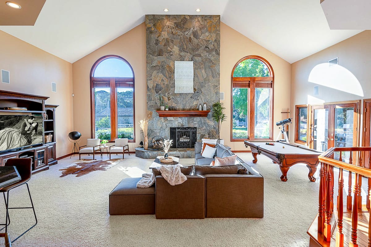 Natural light flooding from the large windows and doors into the living room
