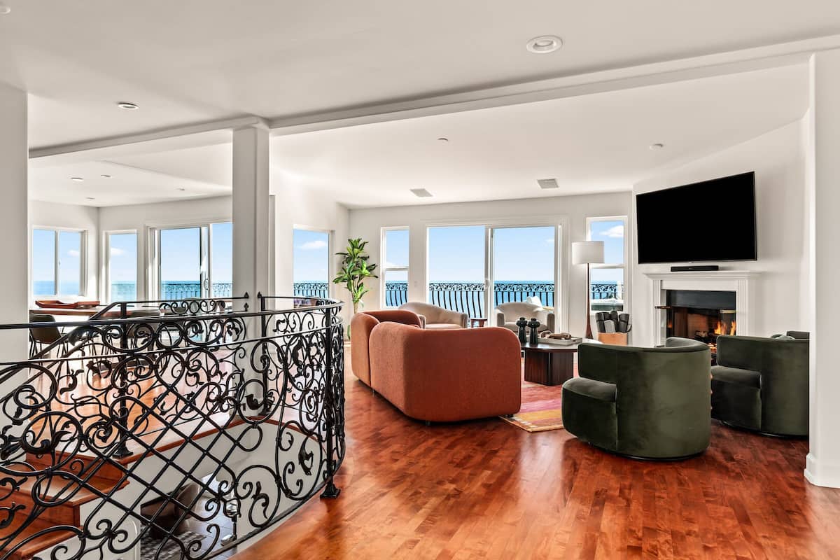 Bright and spacious living room with ocean views, flat screen TV and fireplace