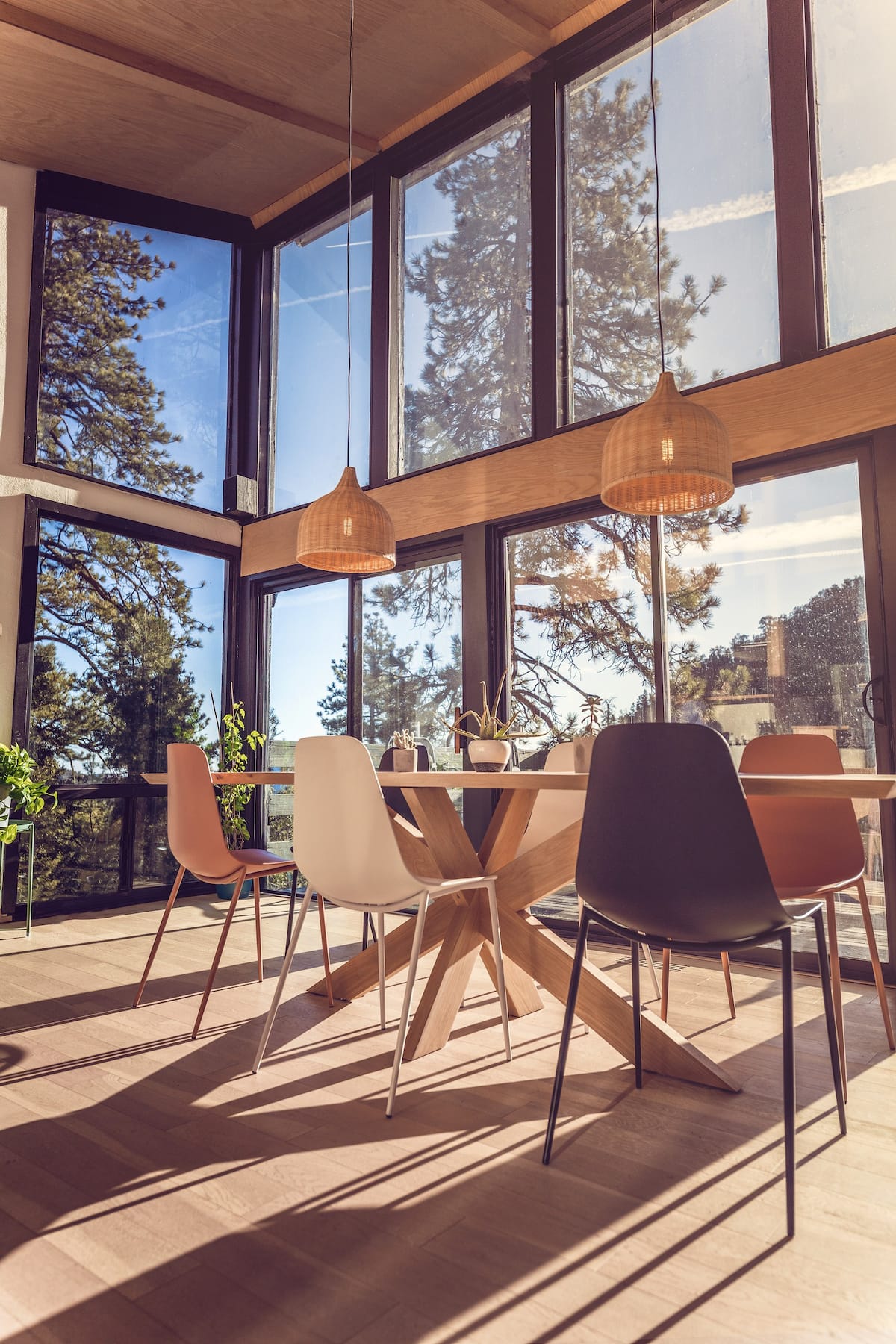 Custom made designer oak table with floor to ceiling windows overlooking the mountains