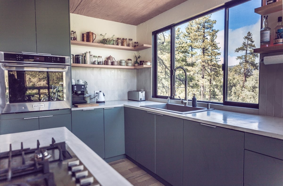 Brand new high end appliances and custom shelving in the open kitchen