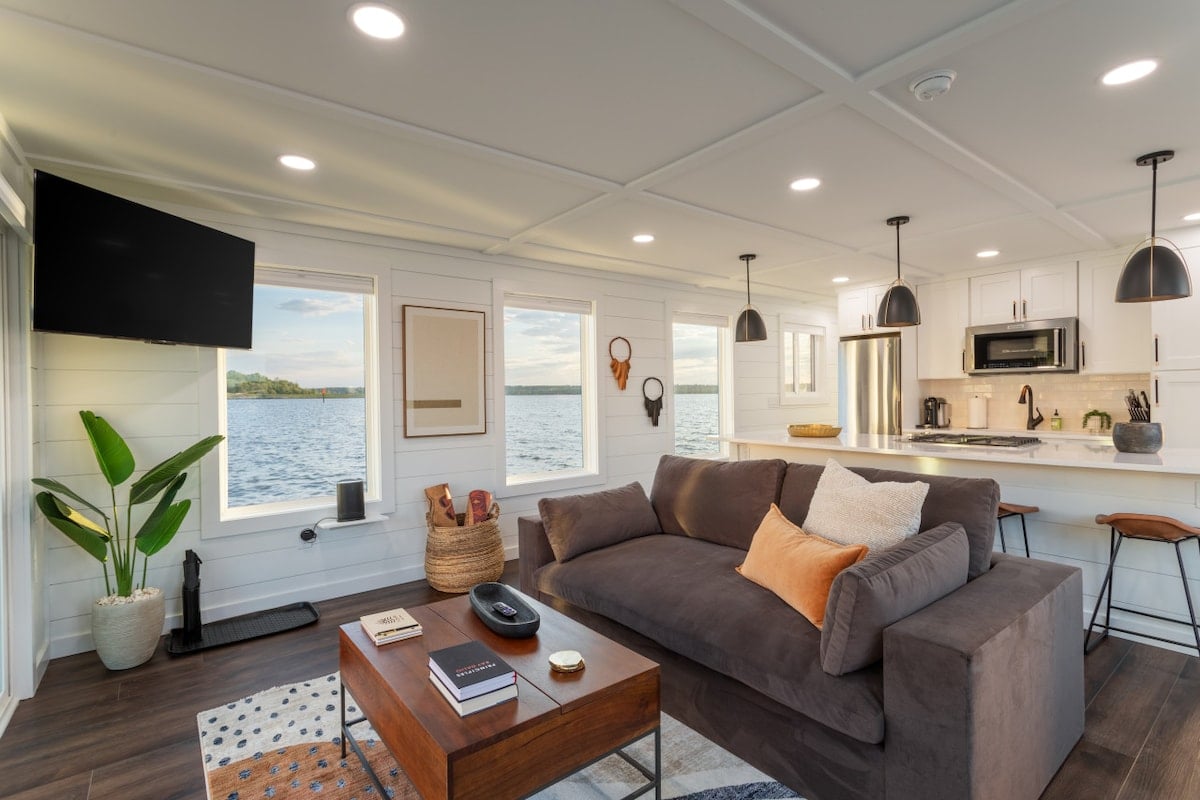 CAPTION:
Experience the serene charm of "Property" in Oxon Hill, where modern coastal elegance meets luxury living. This beautifully designed space features a contemporary open-plan layout, highlighted by large windows framing breathtaking water views. The neutral color palette, accented by navy and beige, enhances the peaceful ambiance. Ideal for travelers seeking a tranquil getaway, this property exudes a welcoming and refined atmosphere, perfect for relaxation or entertaining.
