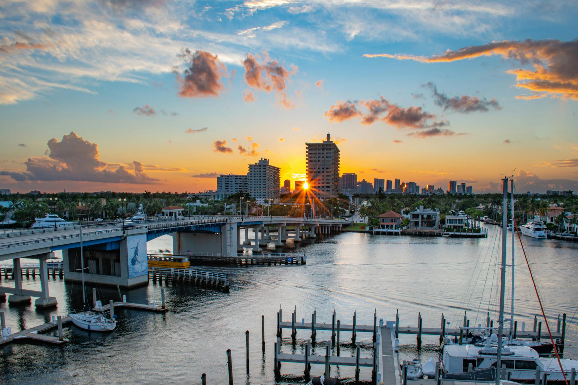 Picturesque sunrise over Las Olas Bridge in Fort Lauderdale, capturing the marina and skyline.
