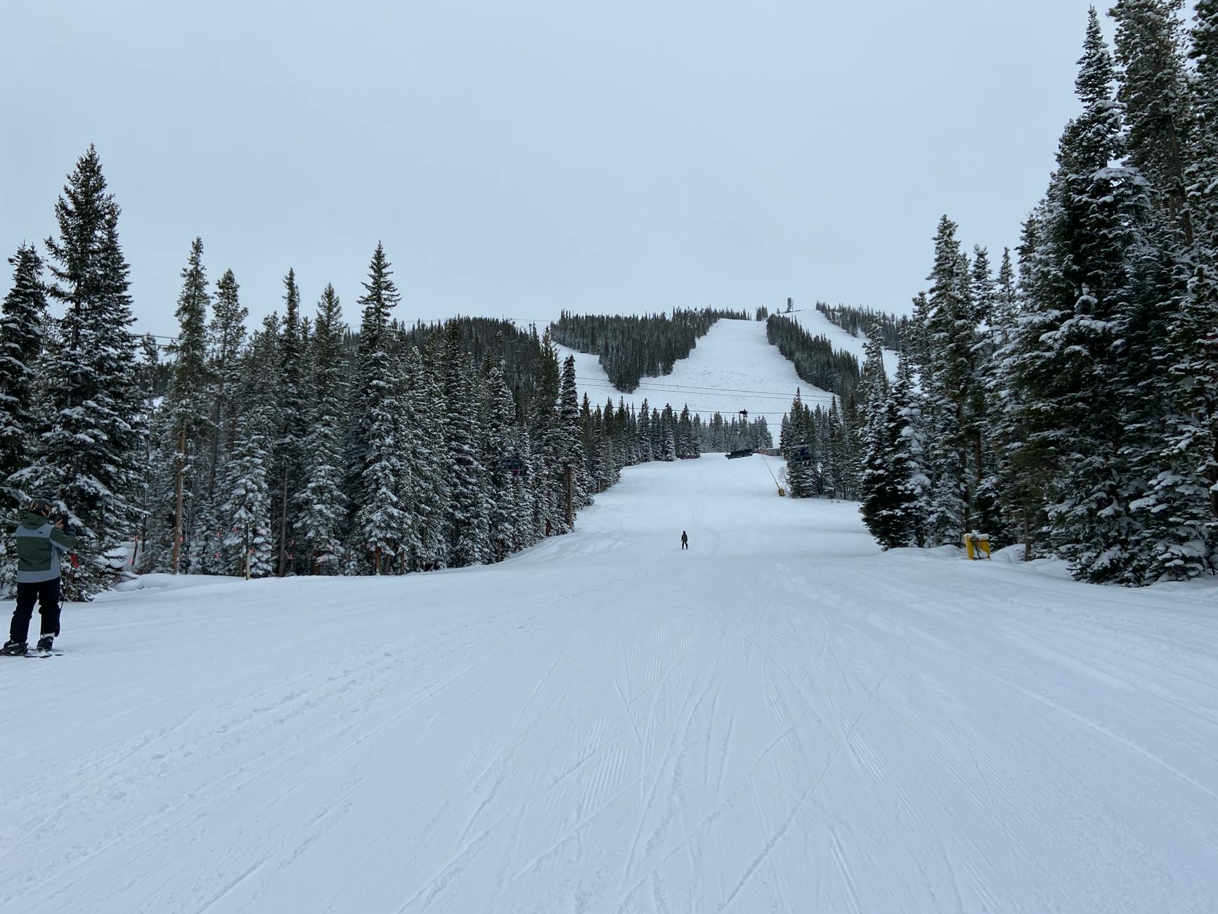 Enjoy skiing at Winter Park, CO, with snow-covered slopes and majestic evergreen trees.