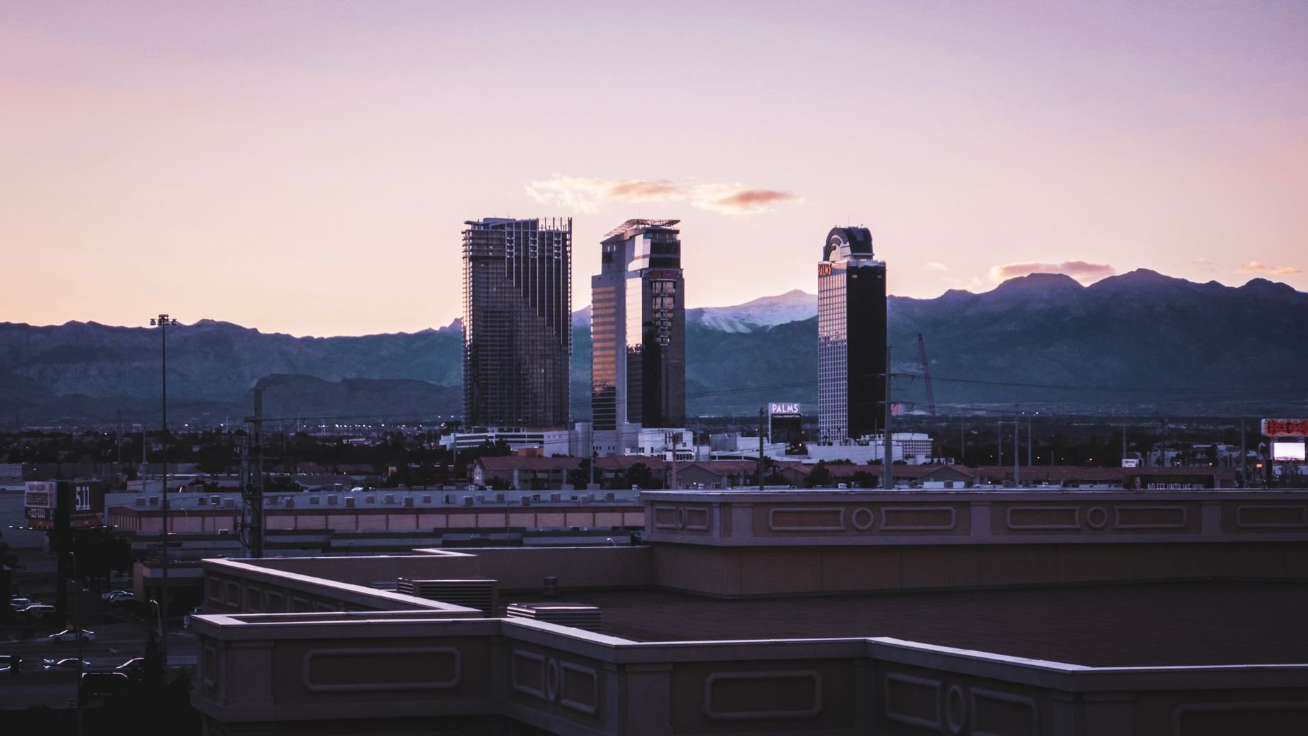 Captivating view of Las Vegas skyline against a mountain backdrop during dusk.