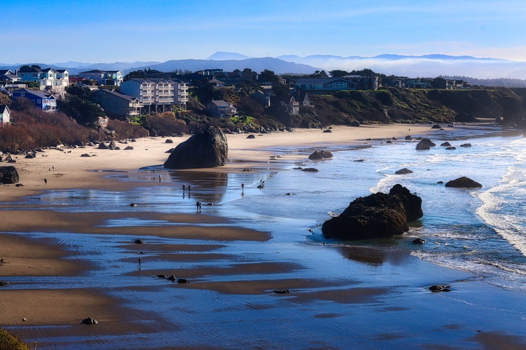 Coastal town on a sunny day with rocky beach.