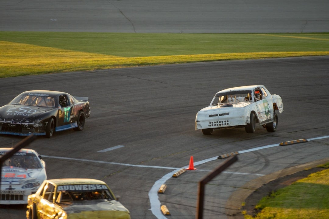 A group of cars driving around a track