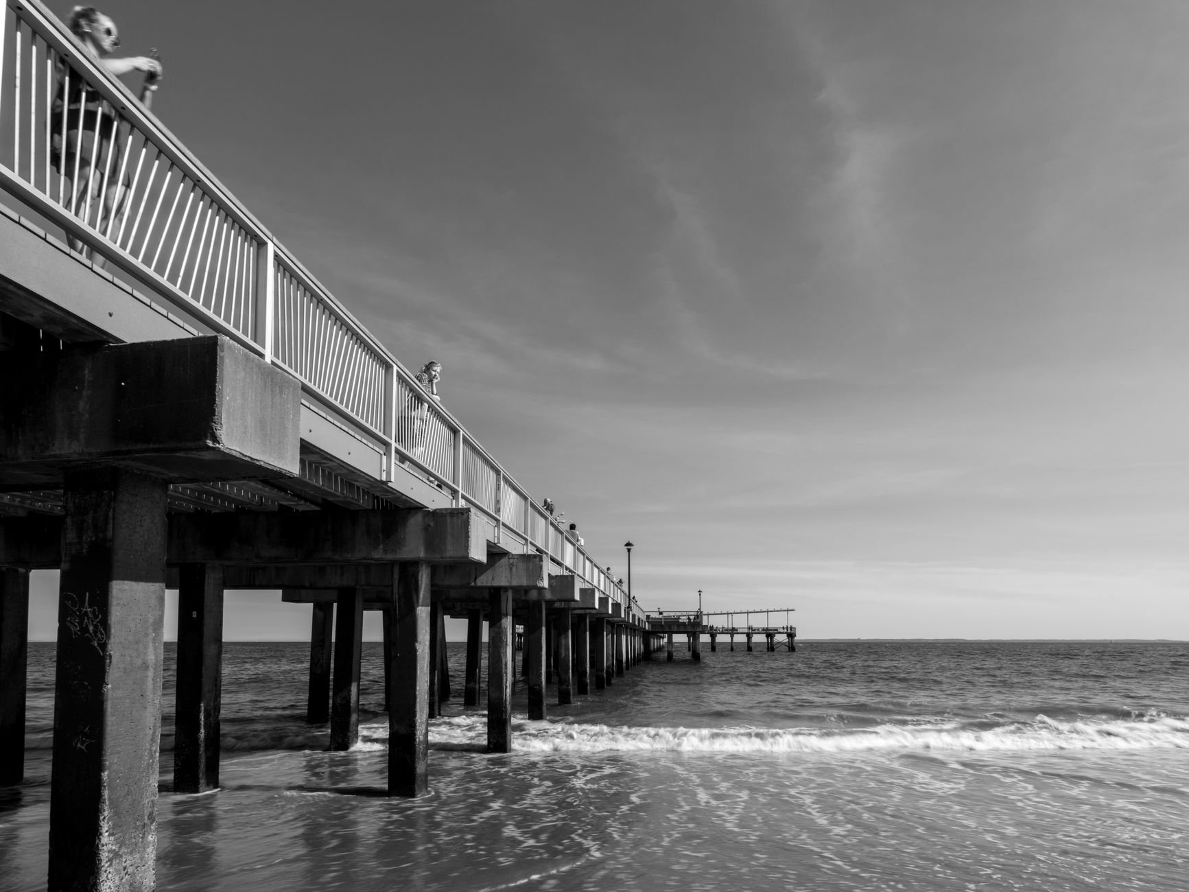 Explore a stunning black and white photo of Coney Island Pier, capturing the ocean's beauty.