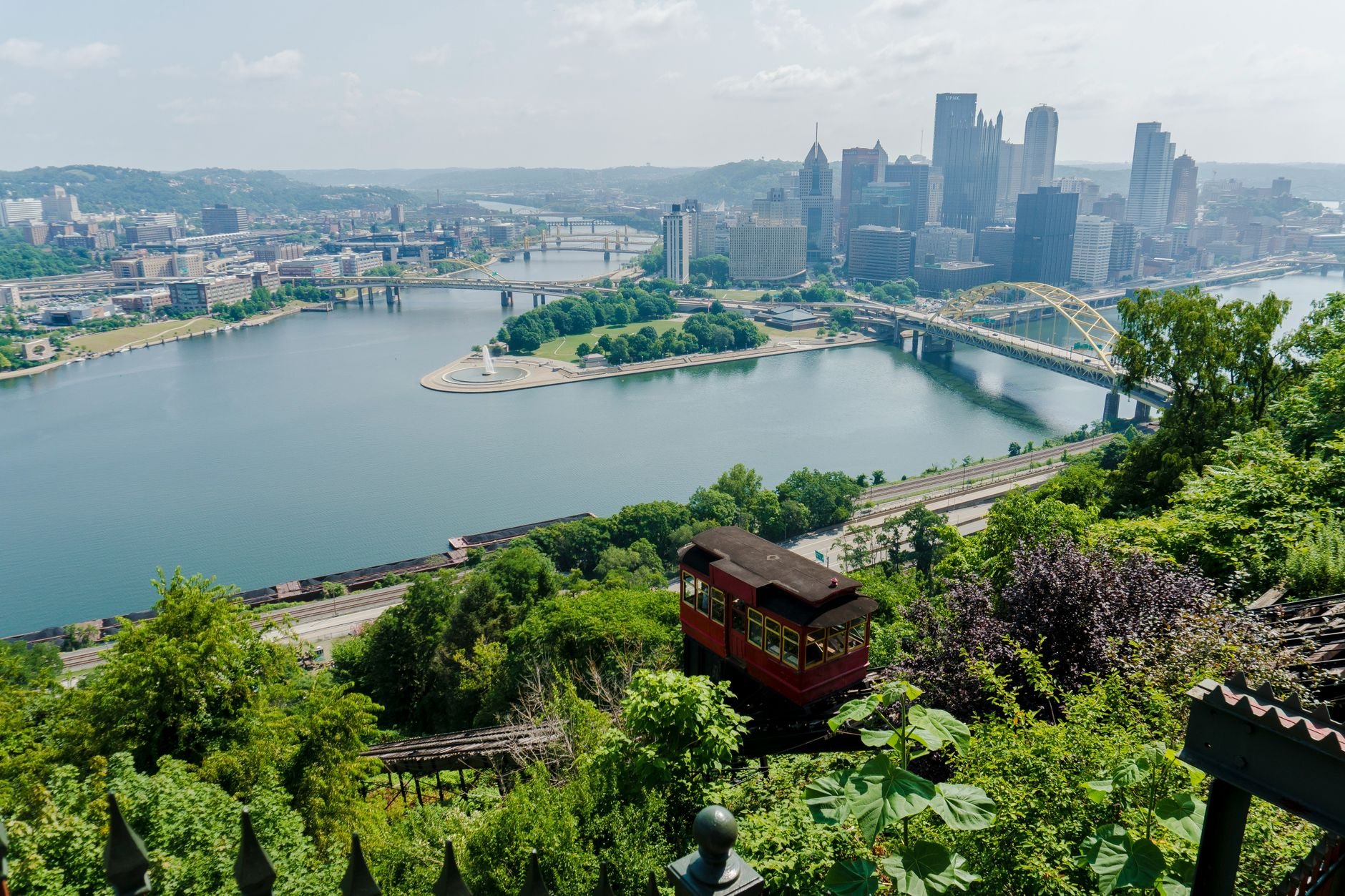 A breathtaking aerial view of Pittsburgh's skyline, river, and iconic incline during the day.